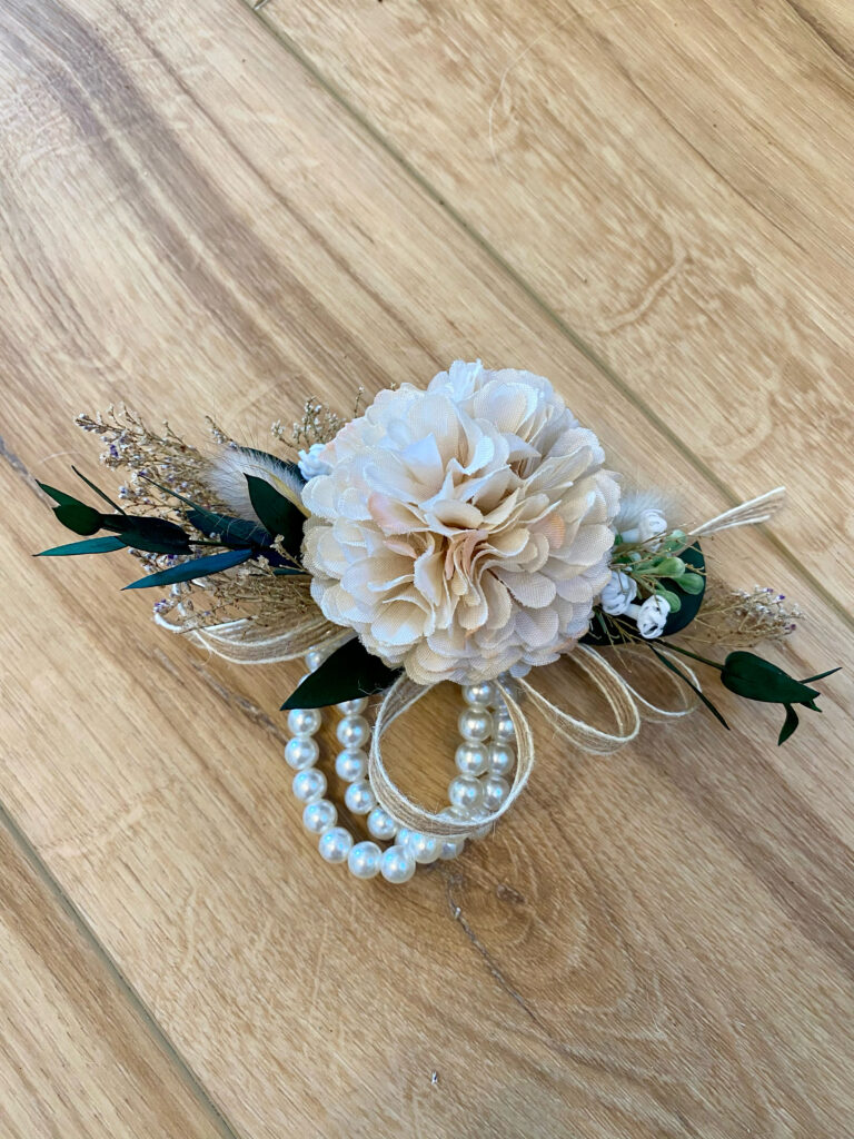 Corsage using blush flower and dried greenery