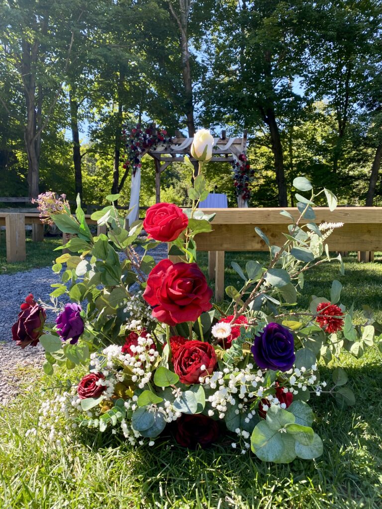 Ground arrangement using red and purple flowers