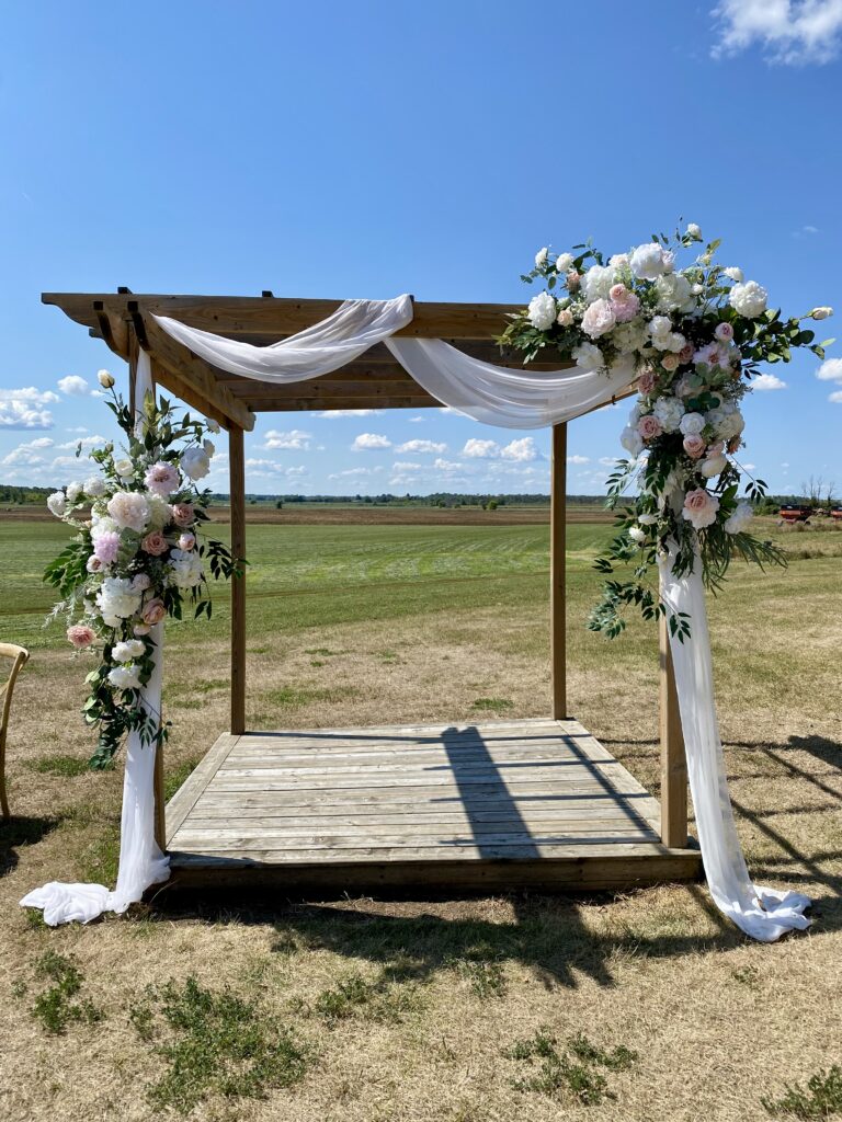 2-piece floral arch using ivory and blush flowers.