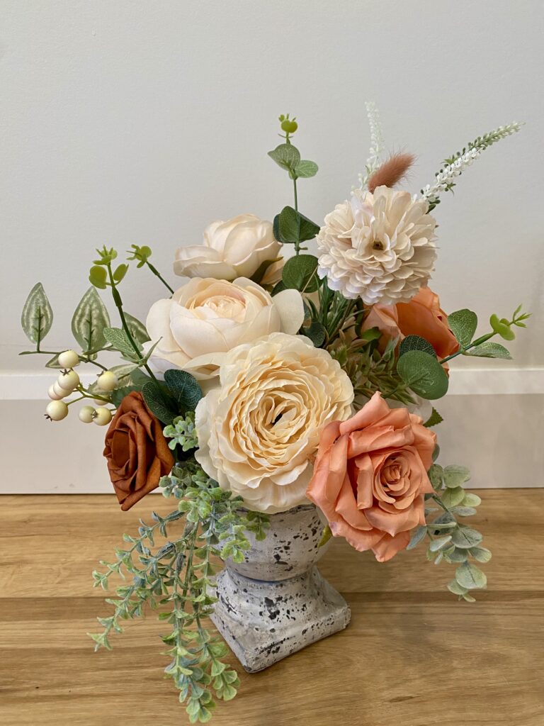 Centerpiece using terracotta, peach, blush and ivory florals