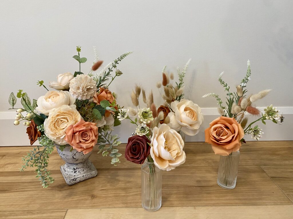 Bud vases and centerpiece using terracotta, burgundy and peach florals